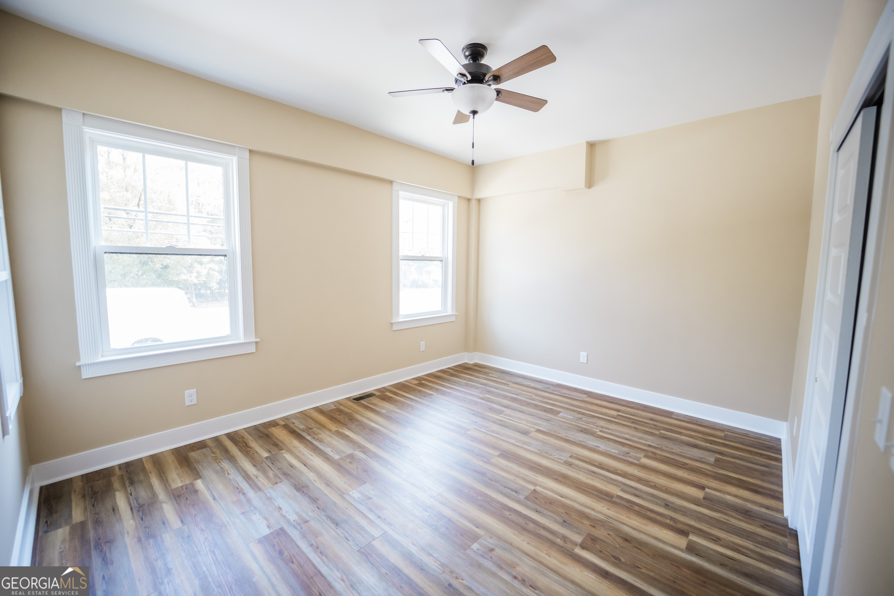 210 West 8th Street, Unit 1 Tifton, GA 31794 - Photo 17 of 23 a view of an empty room with a window and wooden floor
