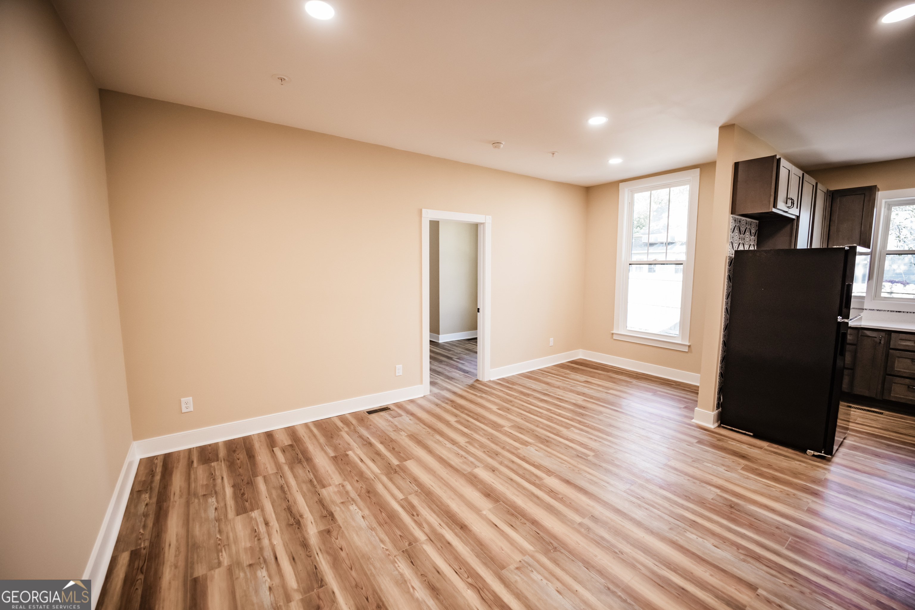 210 West 8th Street, Unit 1 Tifton, GA 31794 - Photo 4 of 23 a view of empty room with wooden floor and windows