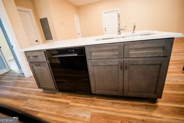 a kitchen with a sink and a stove top oven