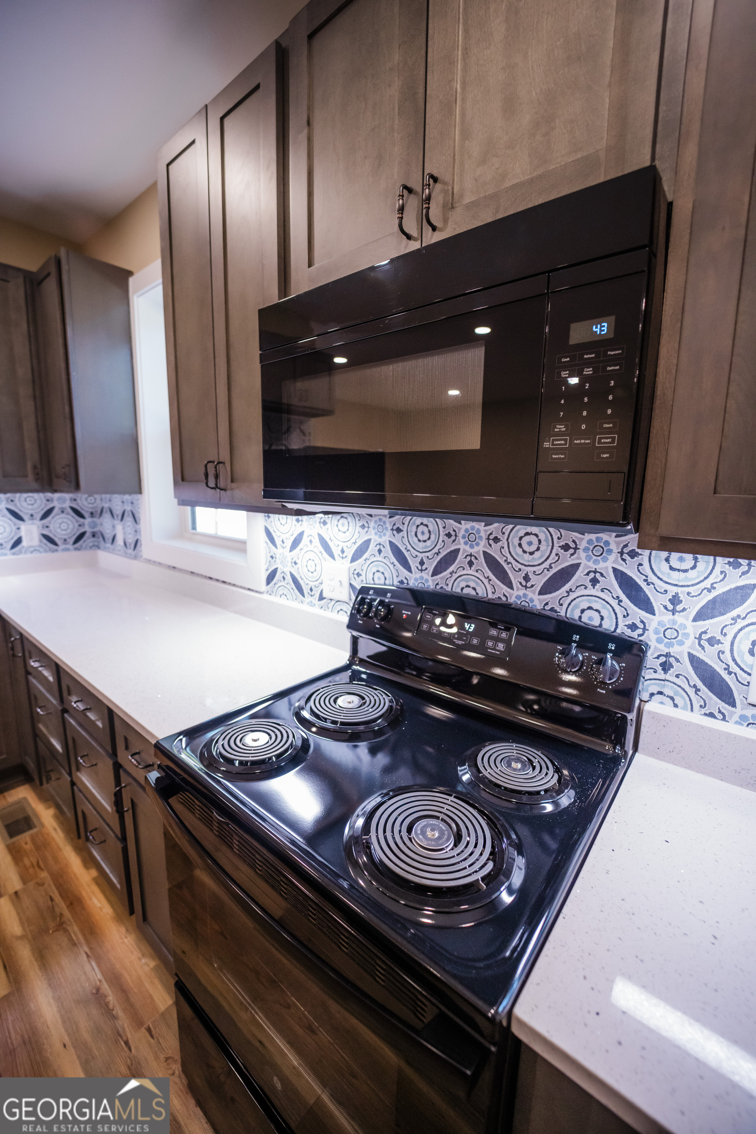 210 West 8th Street, Unit 1 Tifton, GA 31794 - Photo 9 of 23 a stove top oven sitting inside of a kitchen