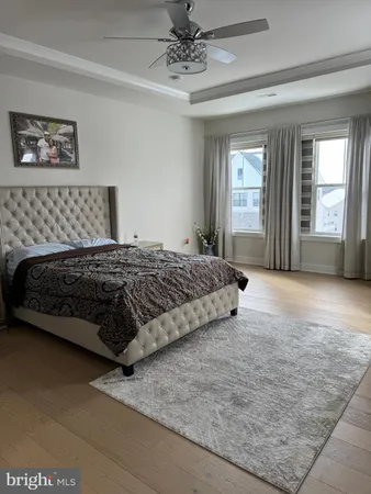 a bedroom with a large bed and a chandelier