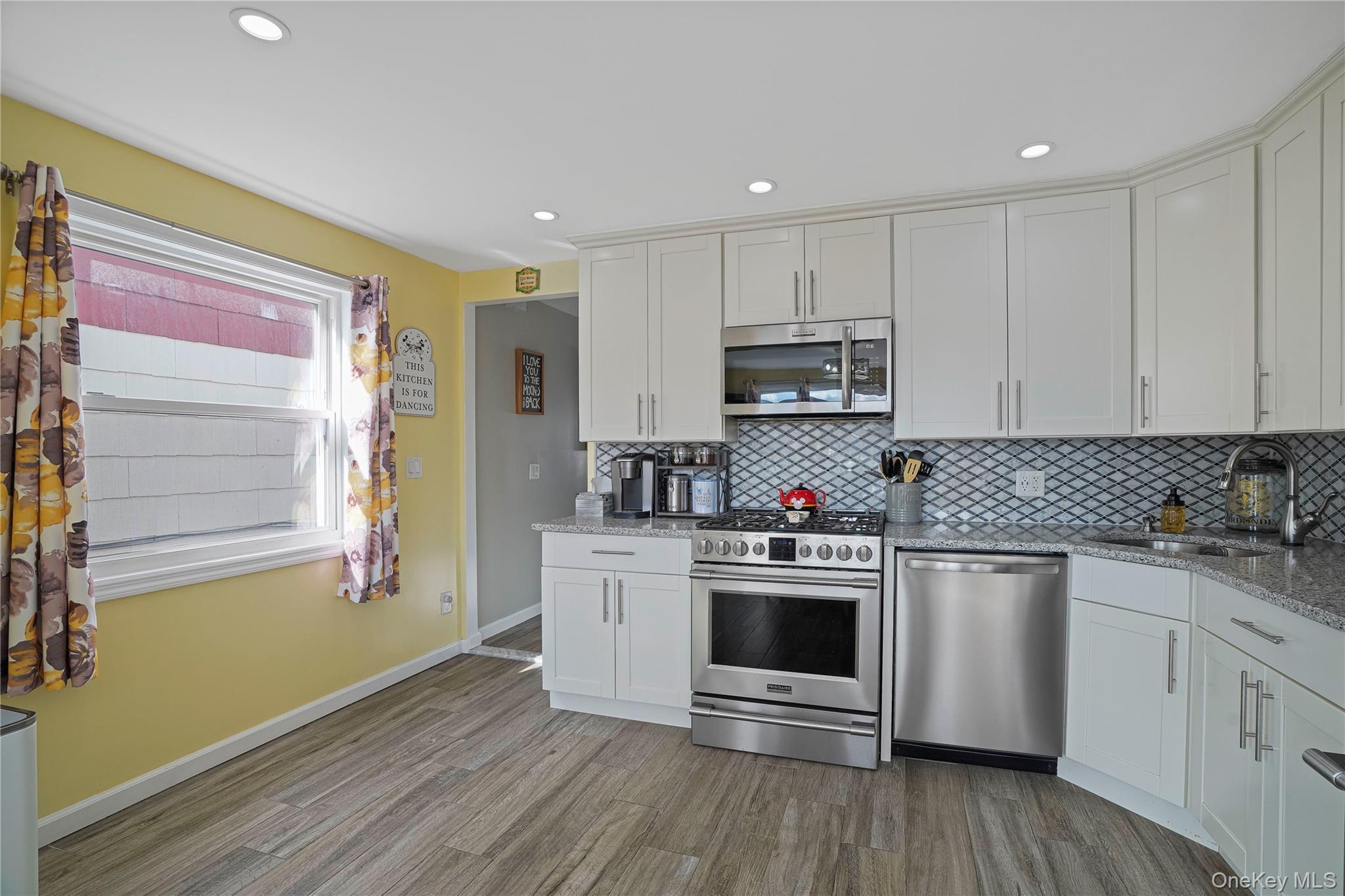 48 Gotham Avenue Brooklyn, NY 11229 - Photo 11 of 38 a kitchen with granite countertop white cabinets and appliances