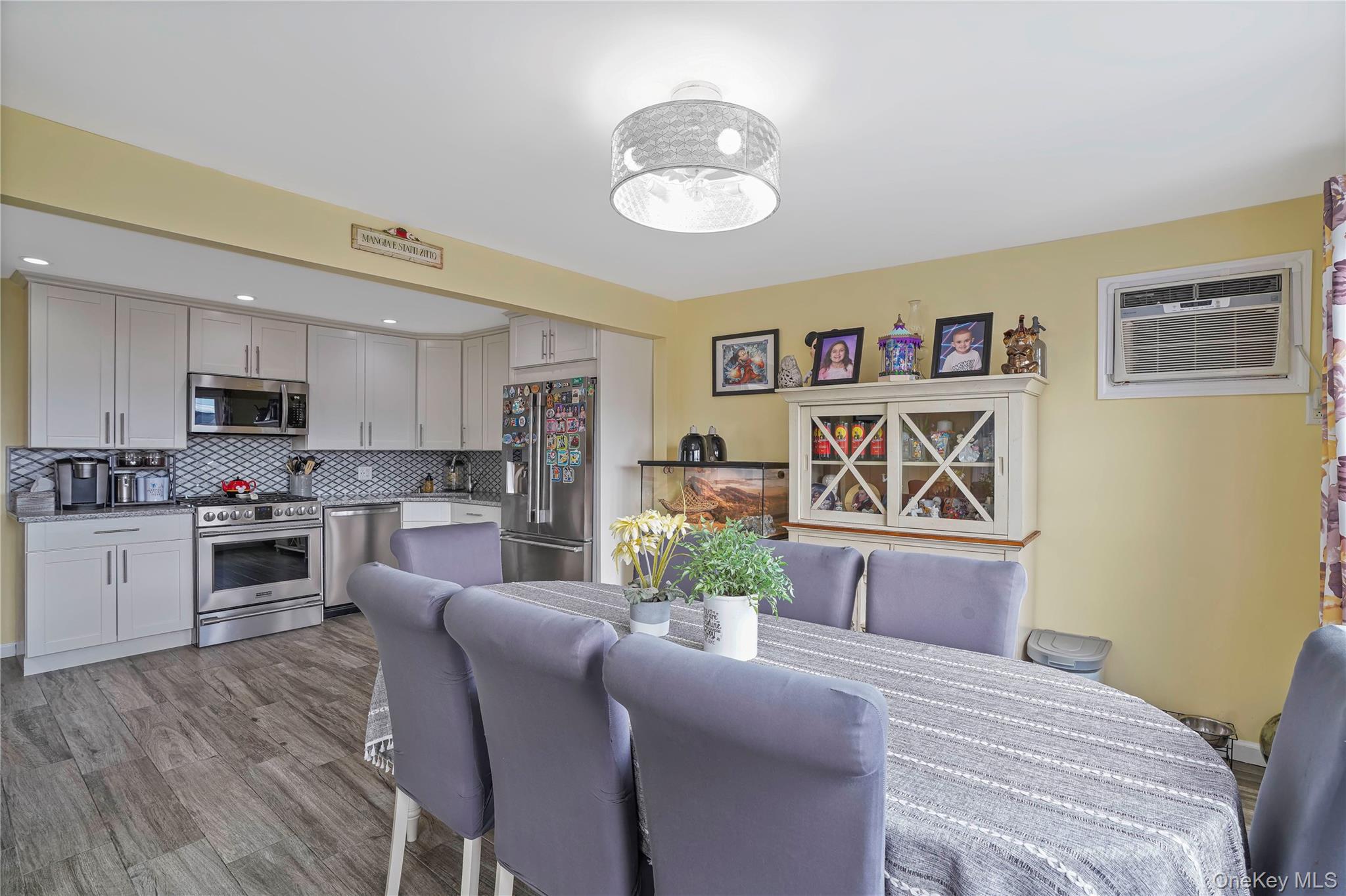 48 Gotham Avenue Brooklyn, NY 11229 - Photo 14 of 38 a living room with kitchen island furniture and a chandelier