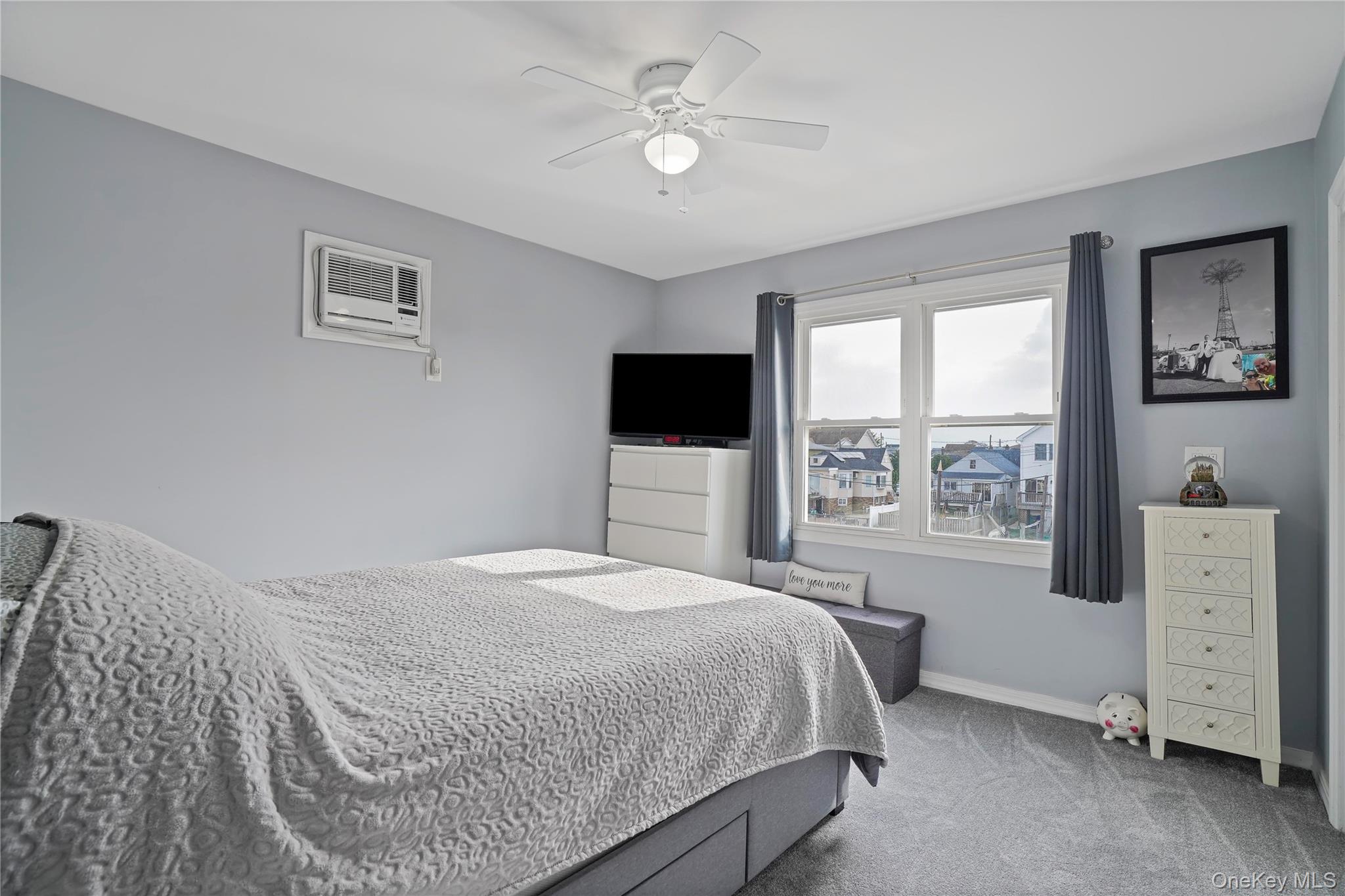 48 Gotham Avenue Brooklyn, NY 11229 - Photo 16 of 38 a bedroom with a large bed and a flat tv screen on dresser