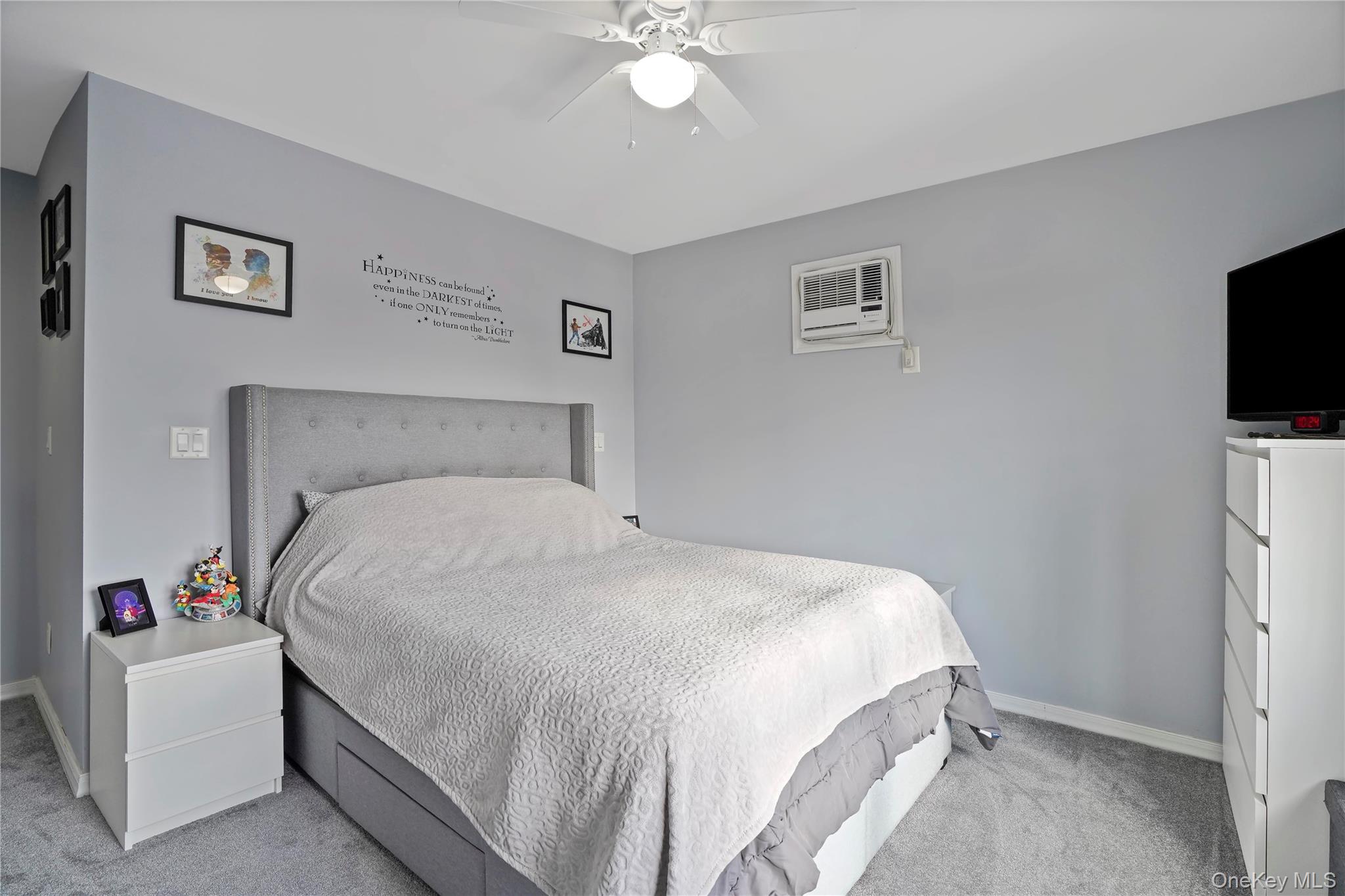 48 Gotham Avenue Brooklyn, NY 11229 - Photo 18 of 38 a bedroom with a white bed and a flat screen tv