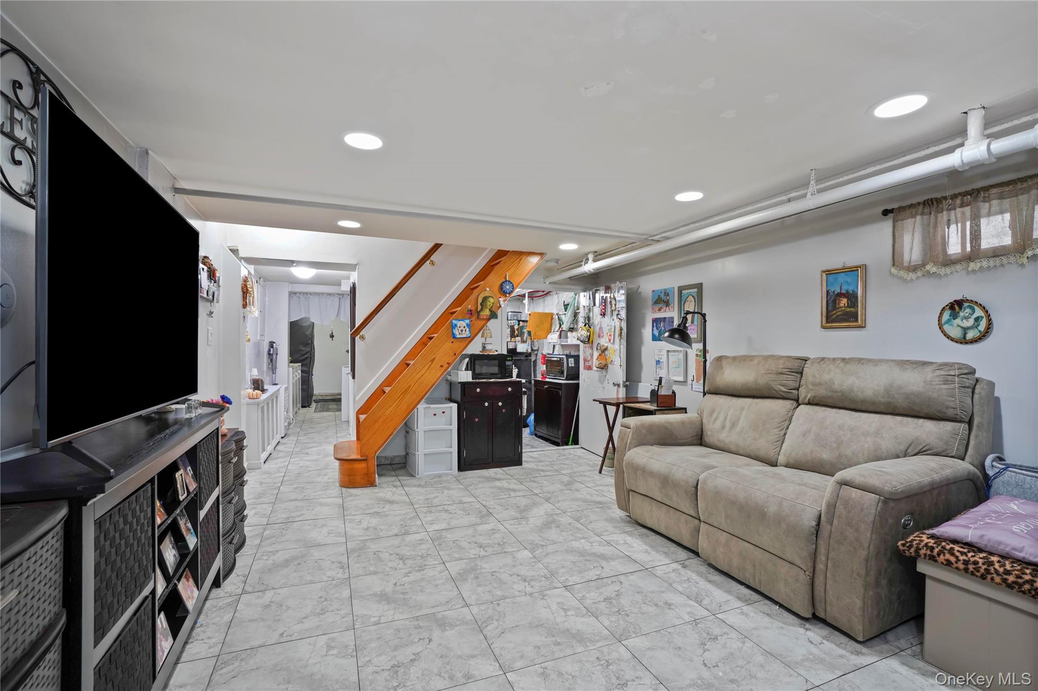 48 Gotham Avenue Brooklyn, NY 11229 - Photo 28 of 38 a living room with furniture and a flat screen tv