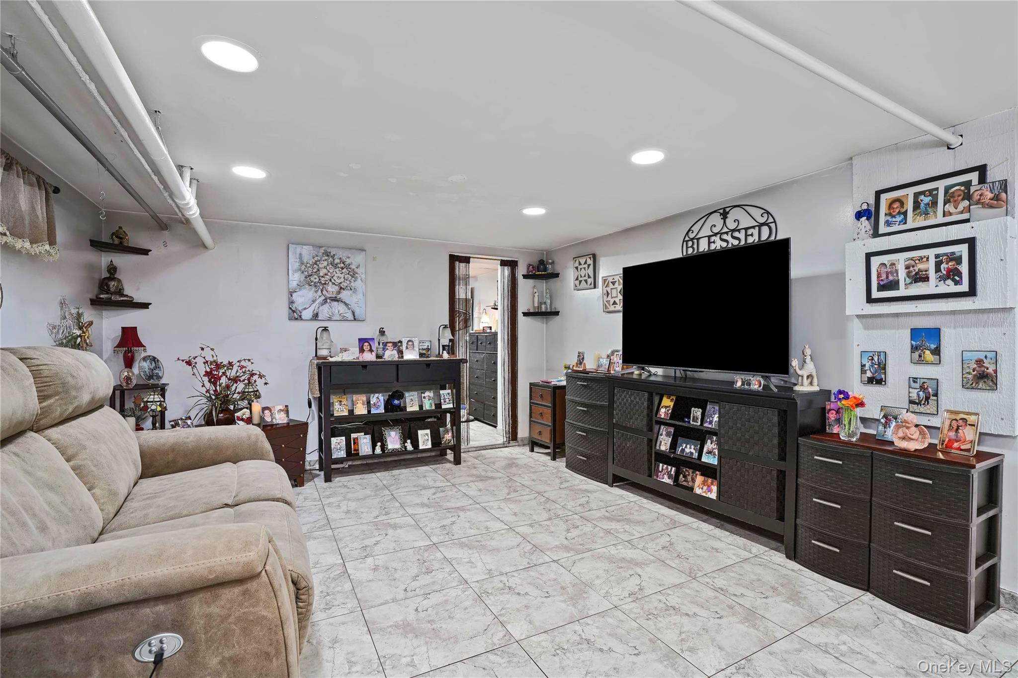 48 Gotham Avenue Brooklyn, NY 11229 - Photo 29 of 38 a living room with furniture and a flat screen tv