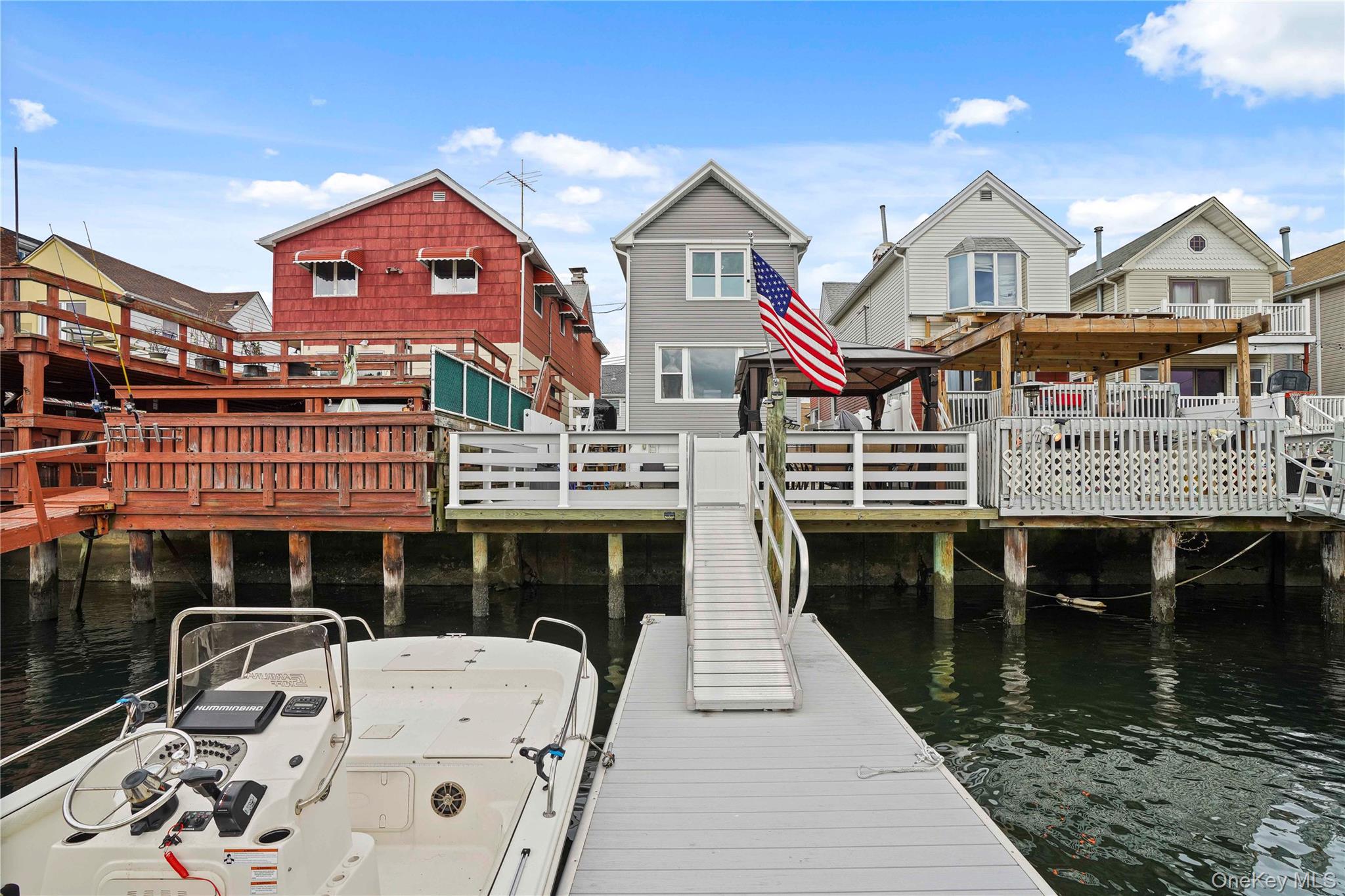 48 Gotham Avenue Brooklyn, NY 11229 - Photo 4 of 38 a front view of a house with swimming pool outdoor seating and mountain view in back