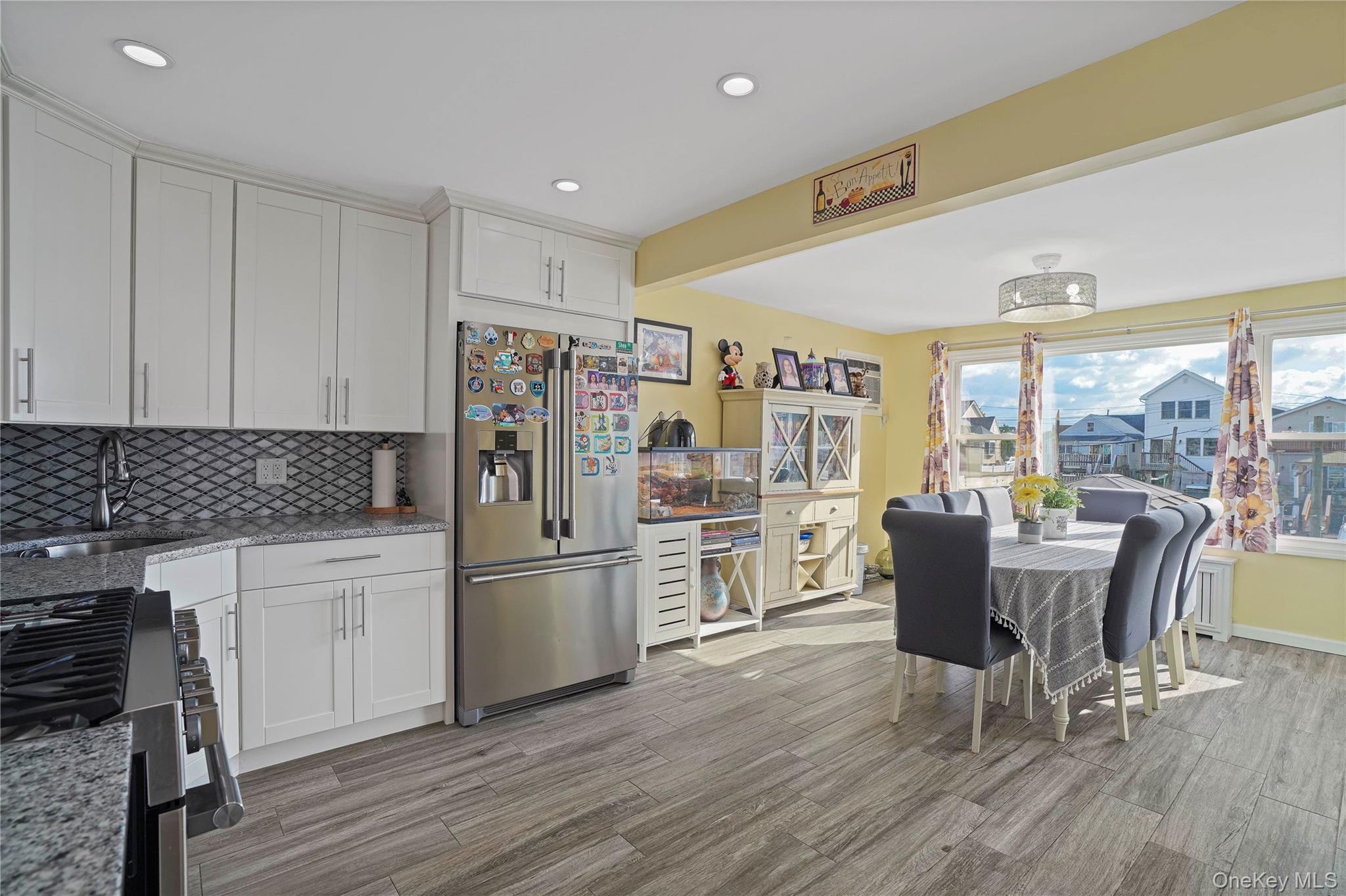 48 Gotham Avenue Brooklyn, NY 11229 - Photo 9 of 38 a kitchen with stainless steel appliances granite countertop a dining table chairs refrigerator and sink