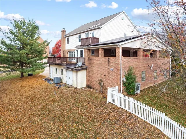 a view of a backyard with a tree