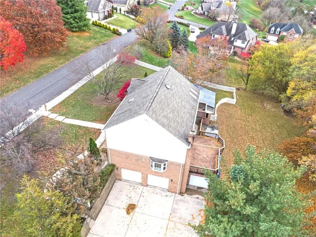 a large white kitchen with kitchen island a sink a stove and a refrigerator