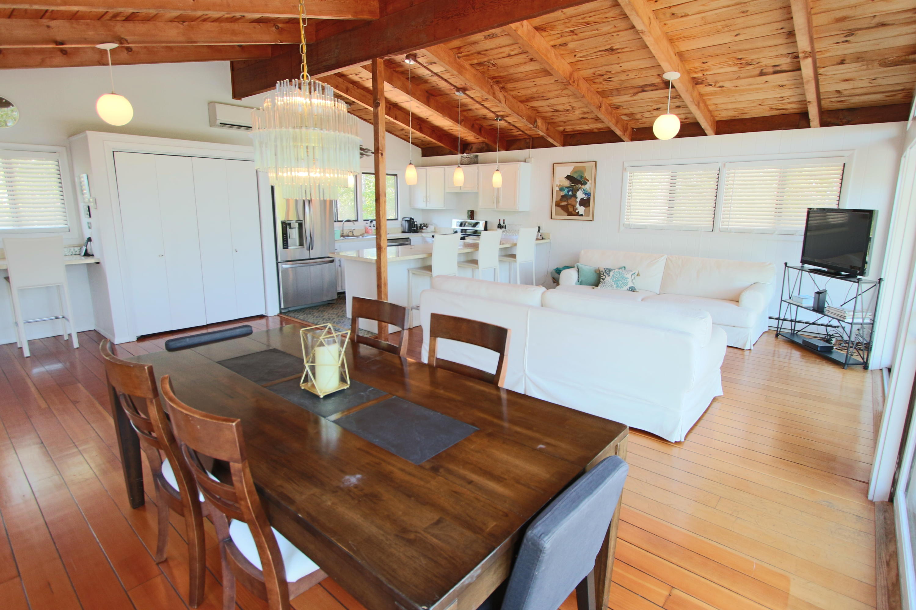 2 Katharine Road Truro, MA 02666 - Photo 15 of 60 a living room with stainless steel appliances furniture a rug and a kitchen view