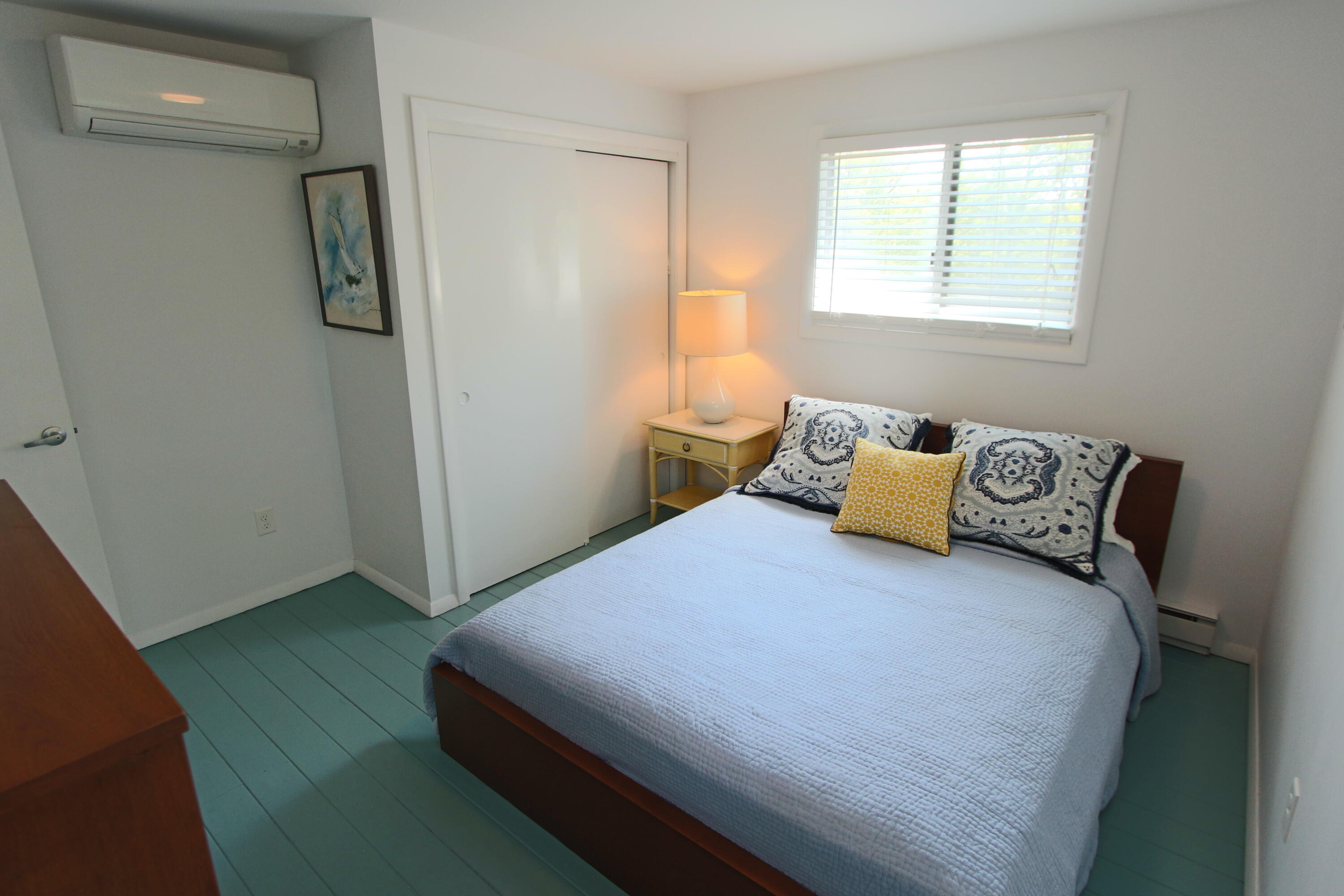 2 Katharine Road Truro, MA 02666 - Photo 26 of 60 a bedroom with a bed and wooden floor