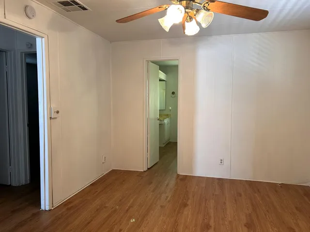 an empty room with wooden floor