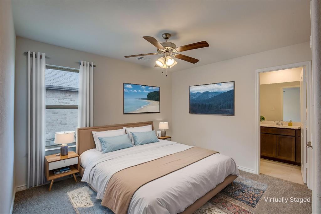 2703 Sayers Way Forney, TX 75126 - Photo 12 of 23 a bedroom with a bed and a chandelier