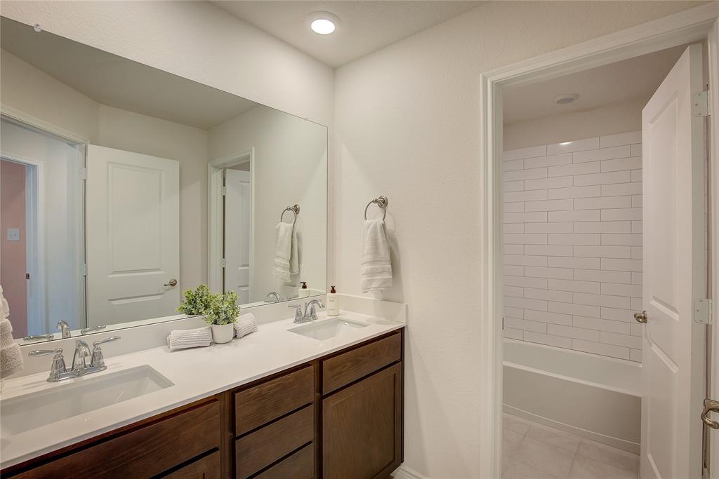 2703 Sayers Way Forney, TX 75126 - Photo 16 of 23 a bathroom with a sink and a mirror