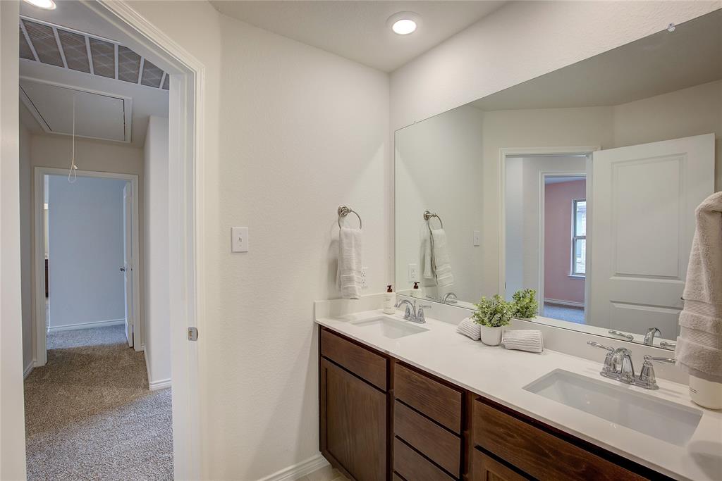 2703 Sayers Way Forney, TX 75126 - Photo 17 of 23 a bathroom with a sink and a mirror