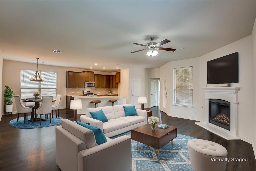 2703 Sayers Way Forney, TX 75126 - Photo 3 of 23 a living room with furniture a fireplace and a flat screen tv