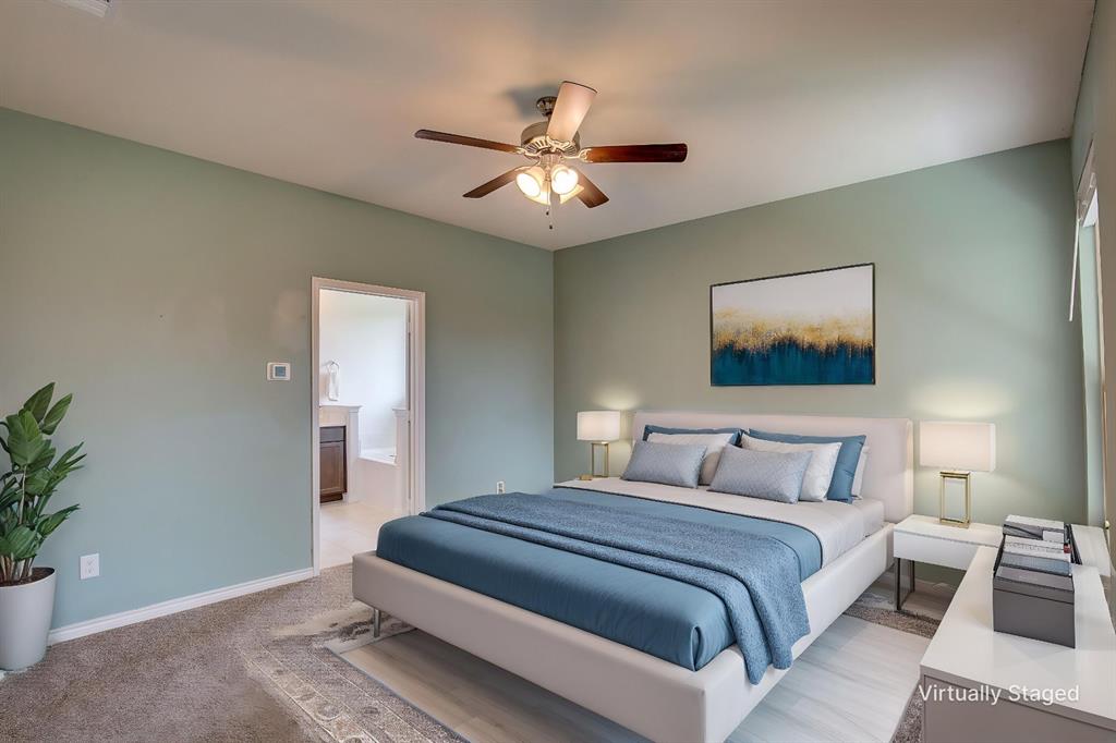 2703 Sayers Way Forney, TX 75126 - Photo 6 of 23 a bedroom with a large bed and a chandelier