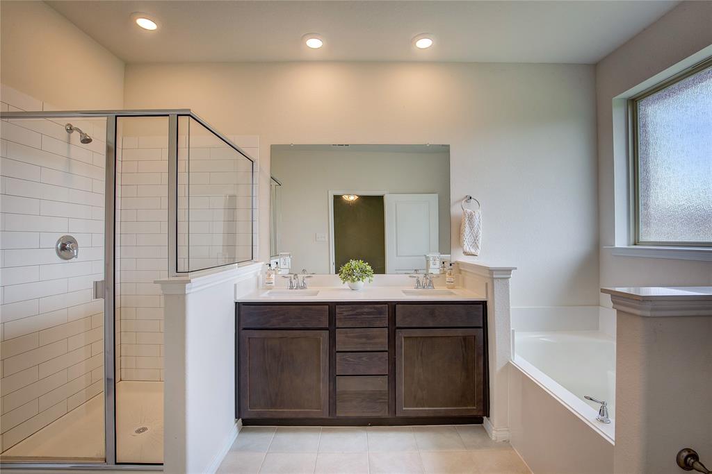 2703 Sayers Way Forney, TX 75126 - Photo 7 of 23 a bathroom with a double vanity sink and mirror with shower