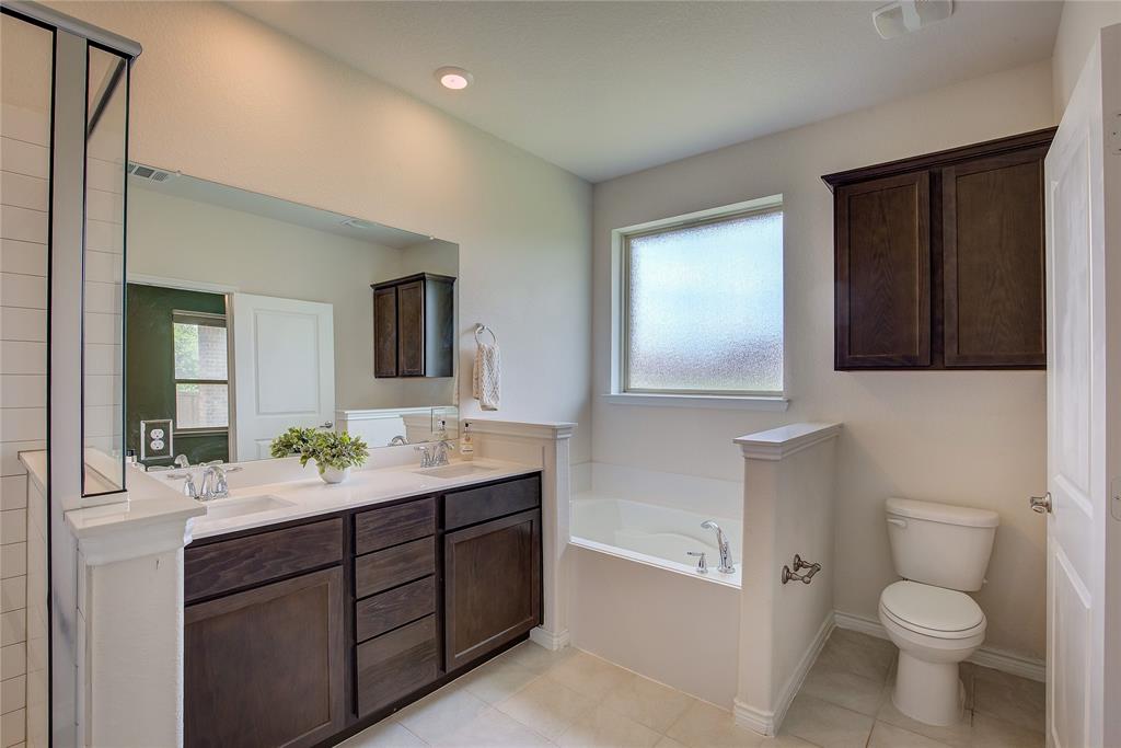 2703 Sayers Way Forney, TX 75126 - Photo 9 of 23 a bathroom with a sink a toilet and mirror
