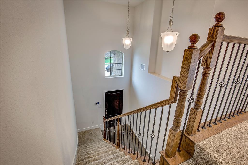 2703 Sayers Way Forney, TX 75126 - Photo 10 of 23 a view of a hallway with wooden floor and stairs