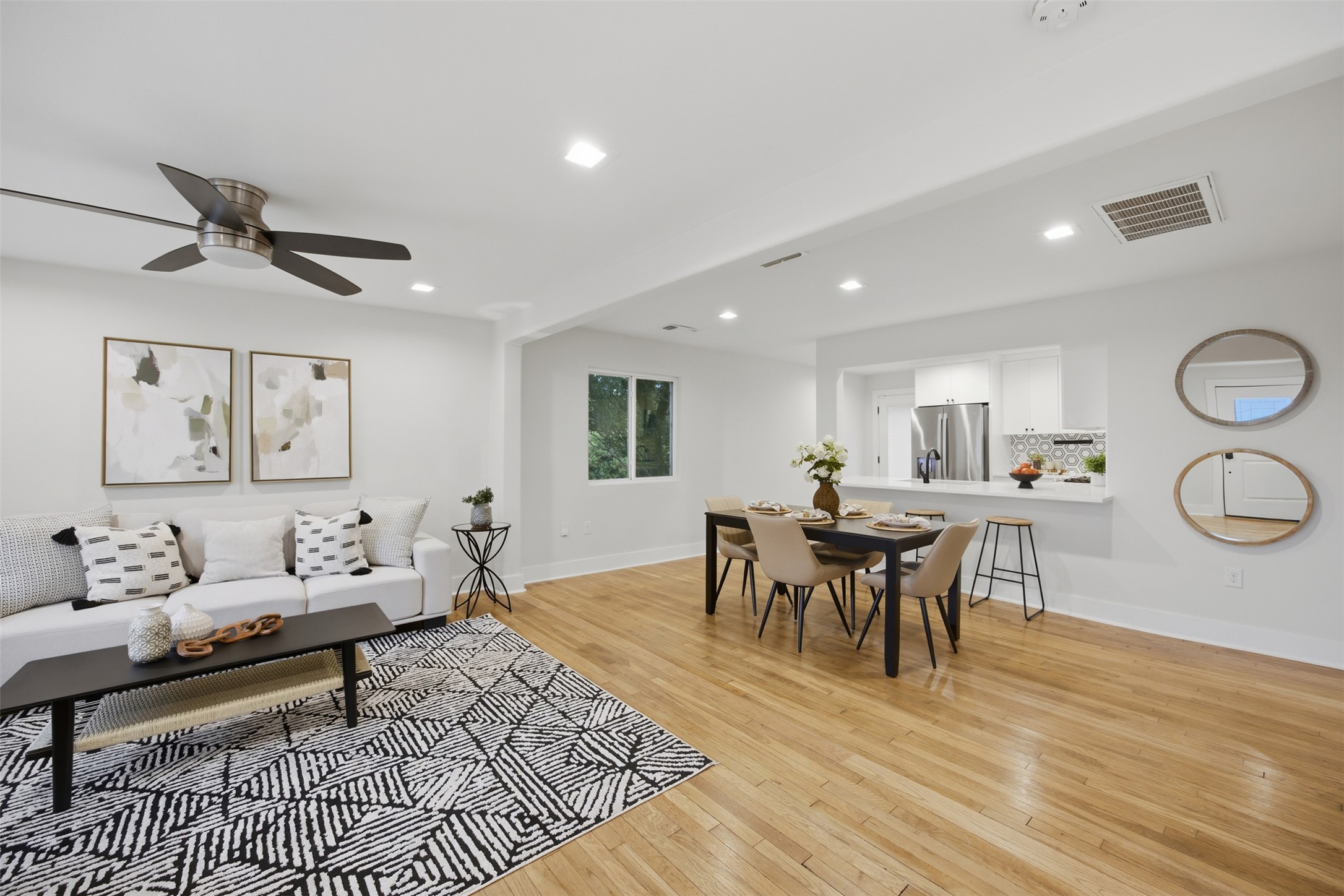 5116 Heflin Lane, Unit 1 Austin, TX 78721 - Photo 7 of 35 An open-concept living area boasts warm hardwood floors, seamlessly connecting to the kitchen.