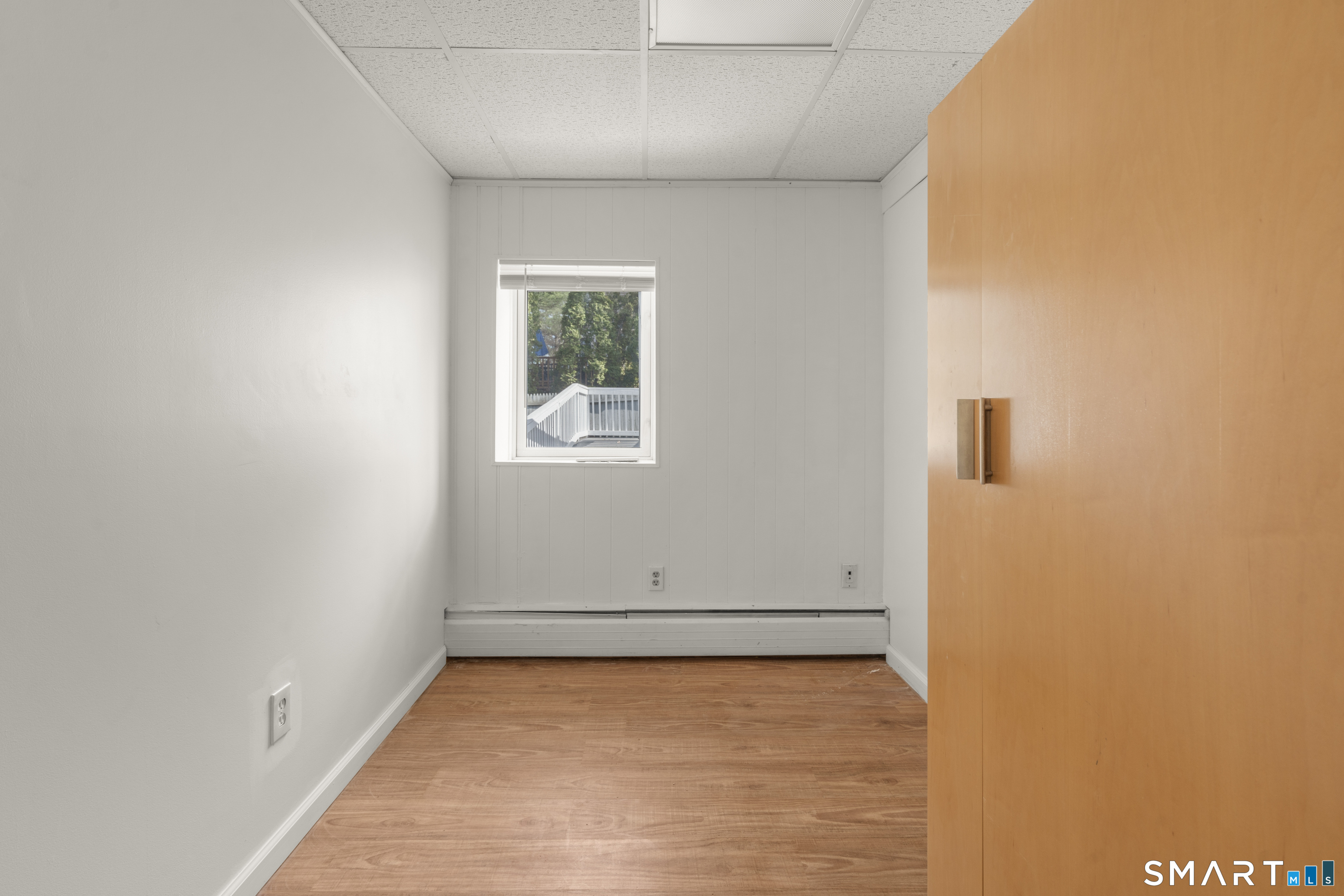 9 Daniel Road, Unit 9B Bristol, CT 06010 - Photo 11 of 16 an empty room with a wooden floor