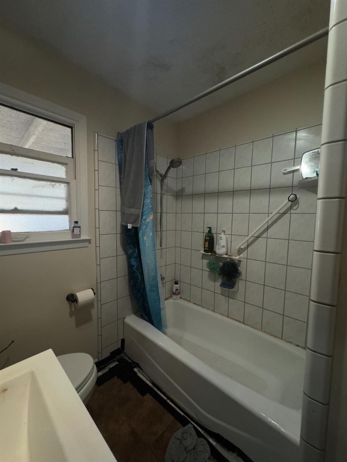 840 J Street Reedley, CA 93654 - Photo 8 of 9 a bathroom with a granite countertop bathtub shower and toilet