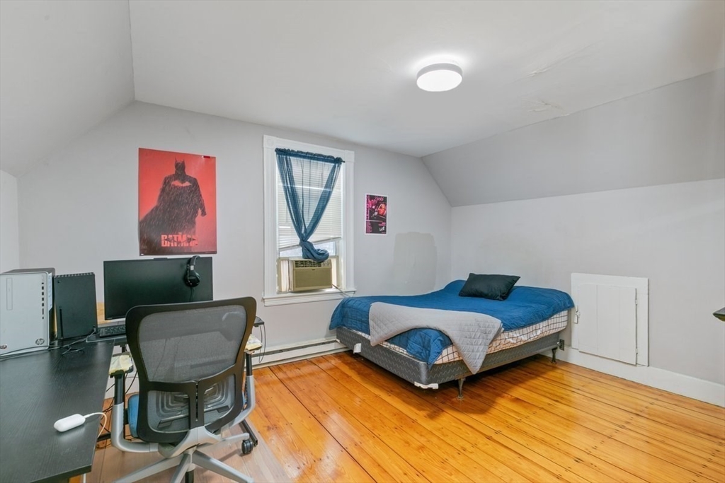 187 Highland Street Boston, MA 02119 - Photo 12 of 21 a living room with furniture rug and a window