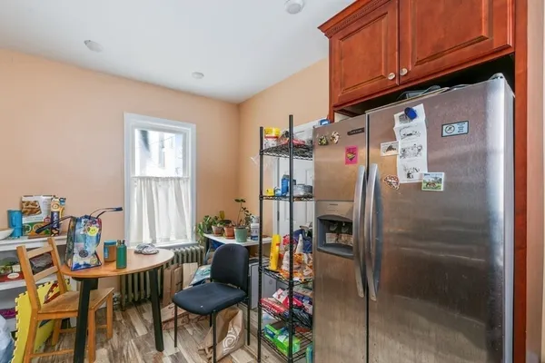 a kitchen with stainless steel appliances granite countertop a refrigerator and a stove top oven