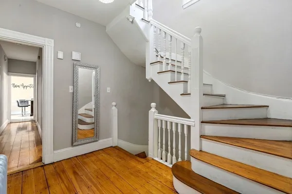 a view of entryway and hall with wooden floor