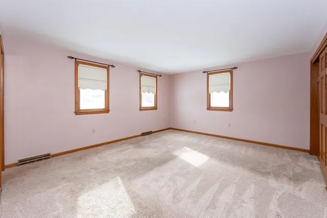 a bathroom with a sink a toilet a mirror and shower