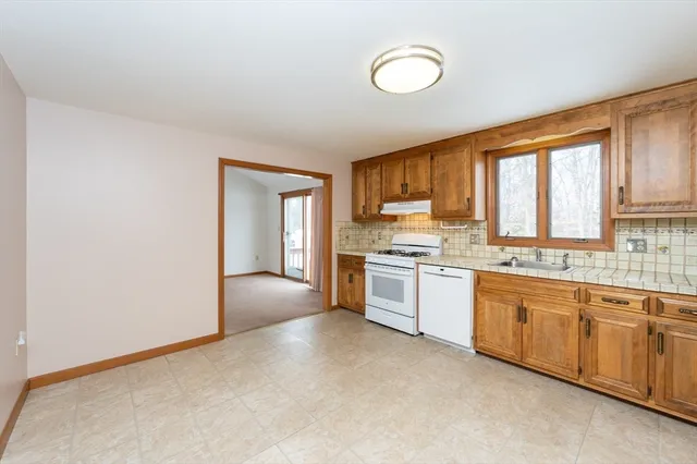 a kitchen with stainless steel appliances granite countertop a stove sink and cabinets