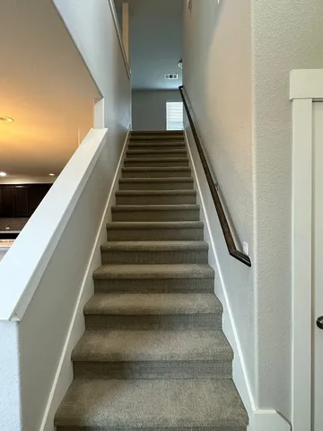 a view of kitchen with cabinets stainless steel appliances and wooden floor