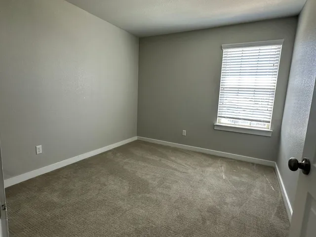 an empty room with a empty space and windows