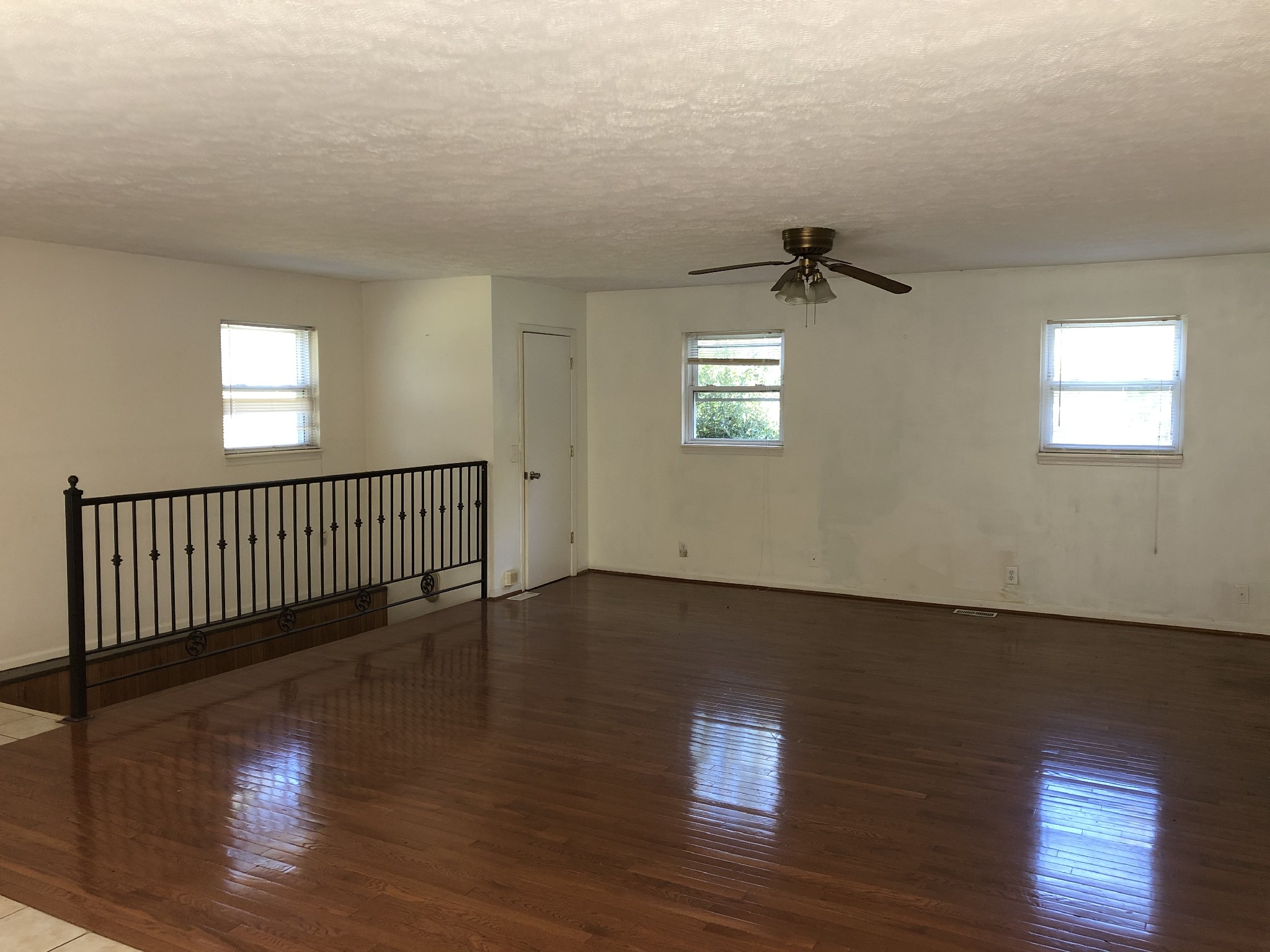 7535 Webster Road Greenbrier, TN 37073 - Photo 7 of 23 an empty room with wooden floor and windows