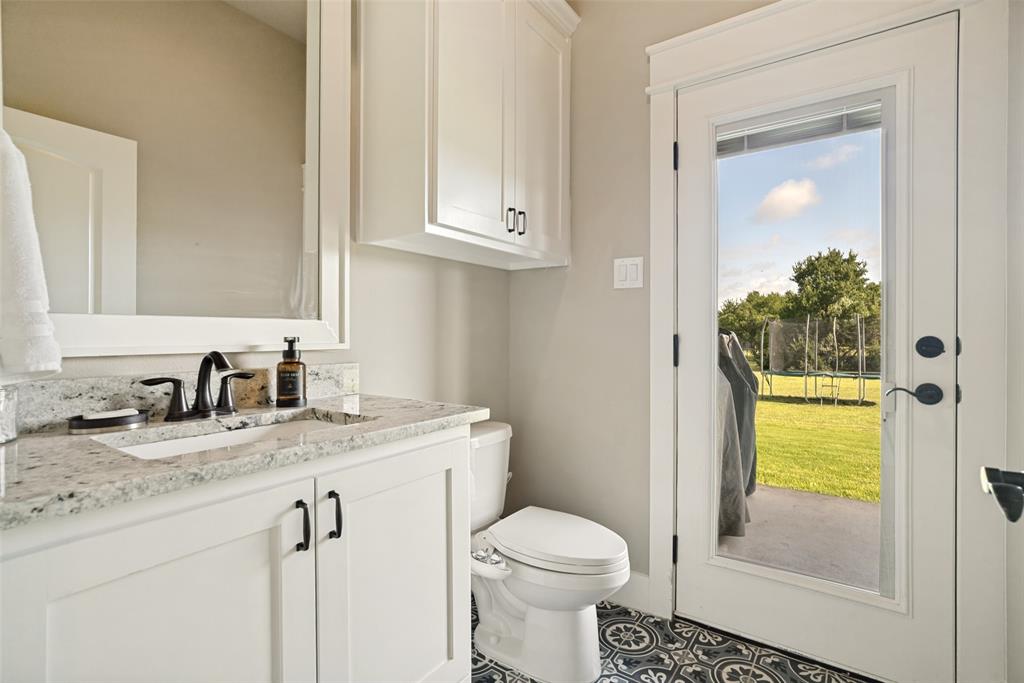 6913 Veal Station Road Weatherford, TX 76085 - Photo 22 of 31 Bathroom featuring a white vanity with a granite countertop and dark bronze fixtures