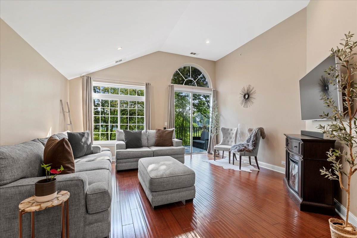 1636 Columbia Circle, Unit 2 Bartlett, IL 60103 - Photo 14 of 47 a living room with furniture and wooden floor
