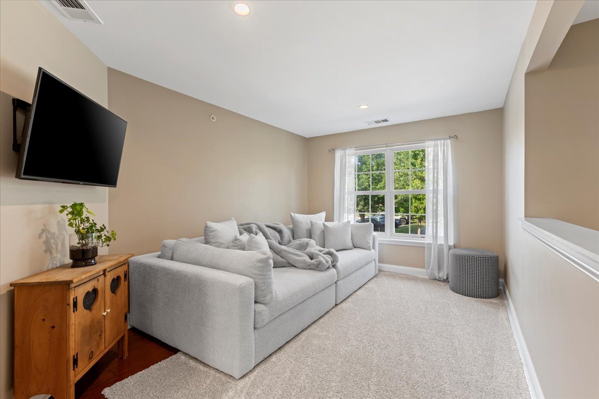 1636 Columbia Circle, Unit 2 Bartlett, IL 60103 - Photo 21 of 47 a living room with furniture and a flat screen tv