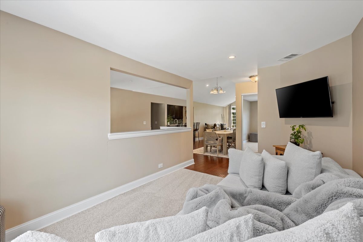 1636 Columbia Circle, Unit 2 Bartlett, IL 60103 - Photo 22 of 47 a living room with furniture and a flat screen tv