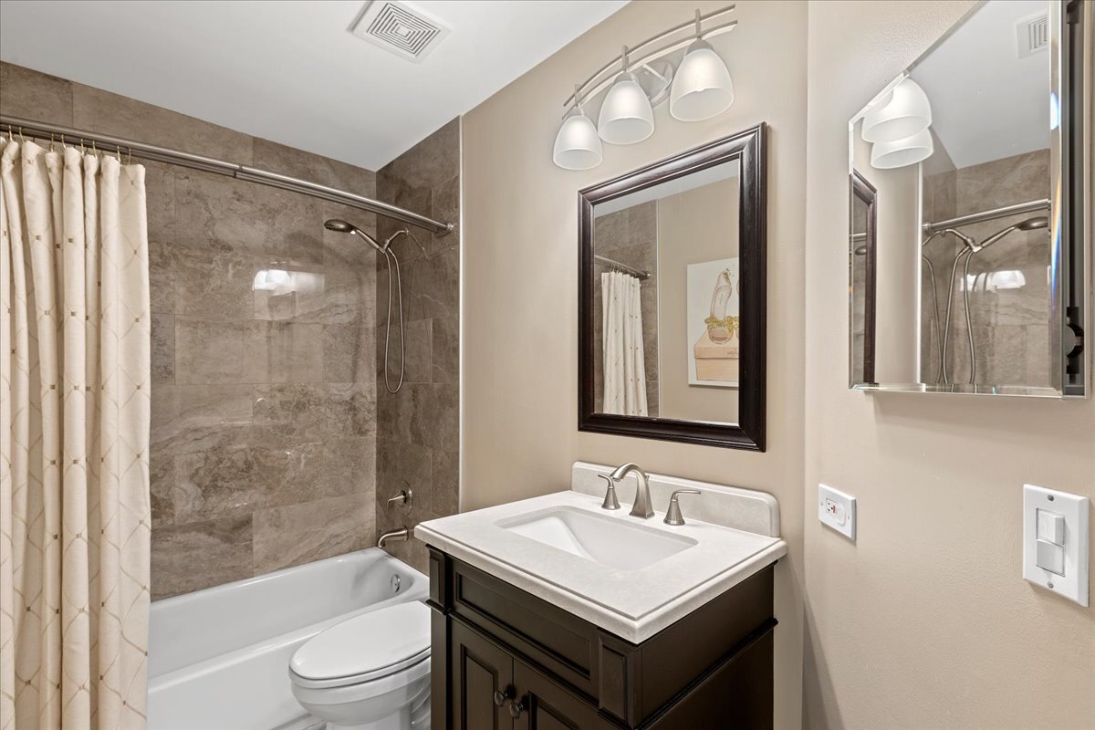 1636 Columbia Circle, Unit 2 Bartlett, IL 60103 - Photo 25 of 47 a bathroom with a sink toilet and shower