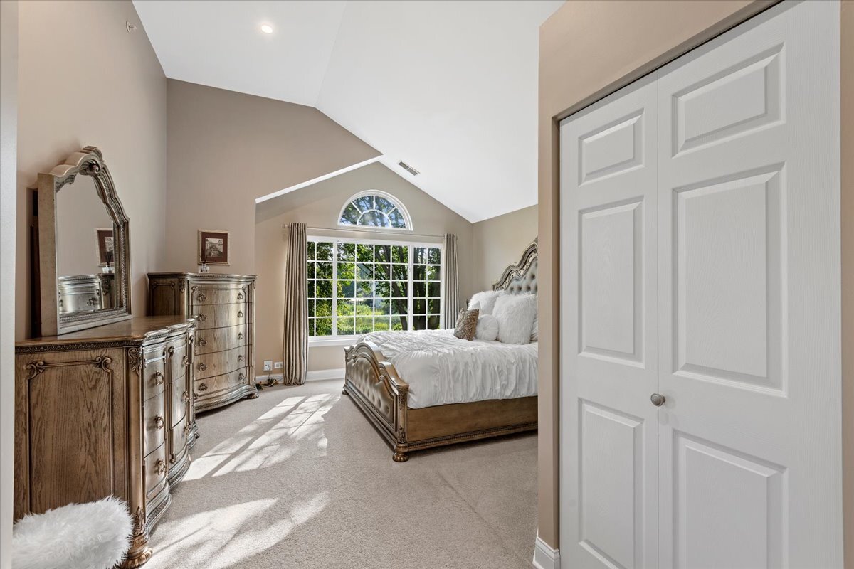 1636 Columbia Circle, Unit 2 Bartlett, IL 60103 - Photo 27 of 47 a spacious bedroom with a bed a fireplace and a large window