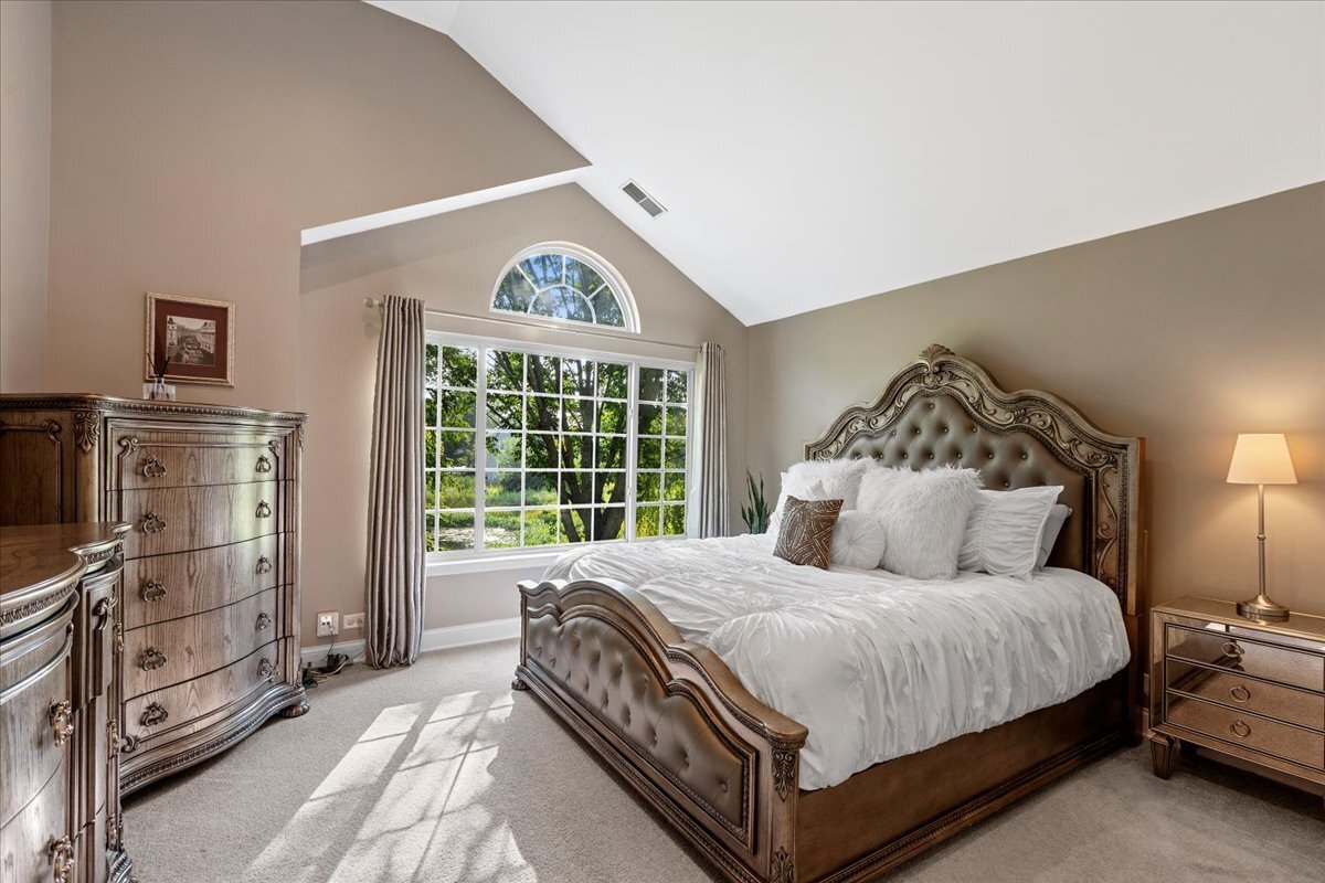 1636 Columbia Circle, Unit 2 Bartlett, IL 60103 - Photo 28 of 47 a bedroom with a bed and a window