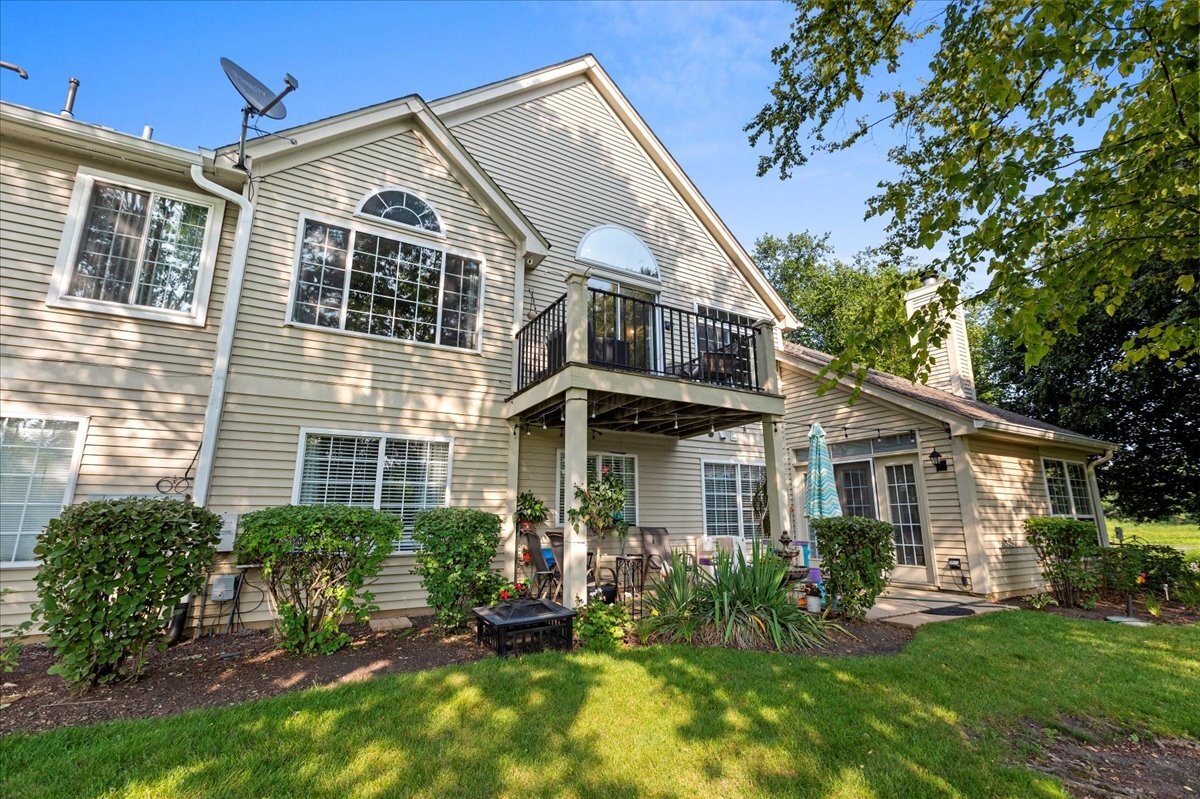 1636 Columbia Circle, Unit 2 Bartlett, IL 60103 - Photo 32 of 47 a front view of a house with a yard and porch