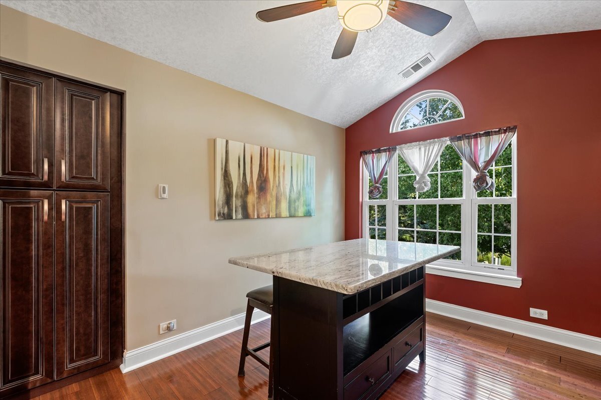 1636 Columbia Circle, Unit 2 Bartlett, IL 60103 - Photo 8 of 47 a kitchen with a wooden floor and a window