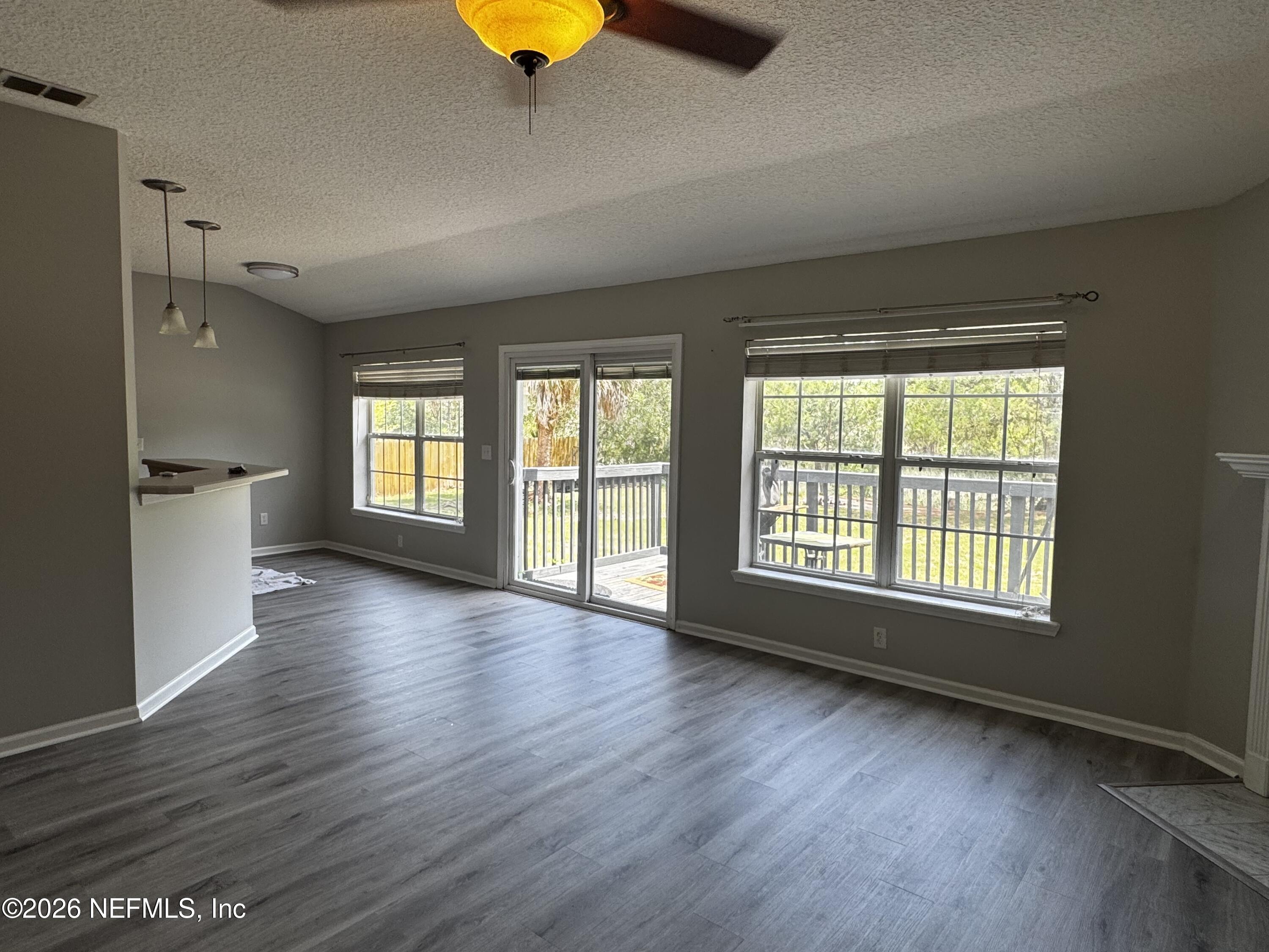 16255 Shellcracker Road Jacksonville, FL 32226 - Photo 17 of 40 a view of an empty room with a window and wooden floor
