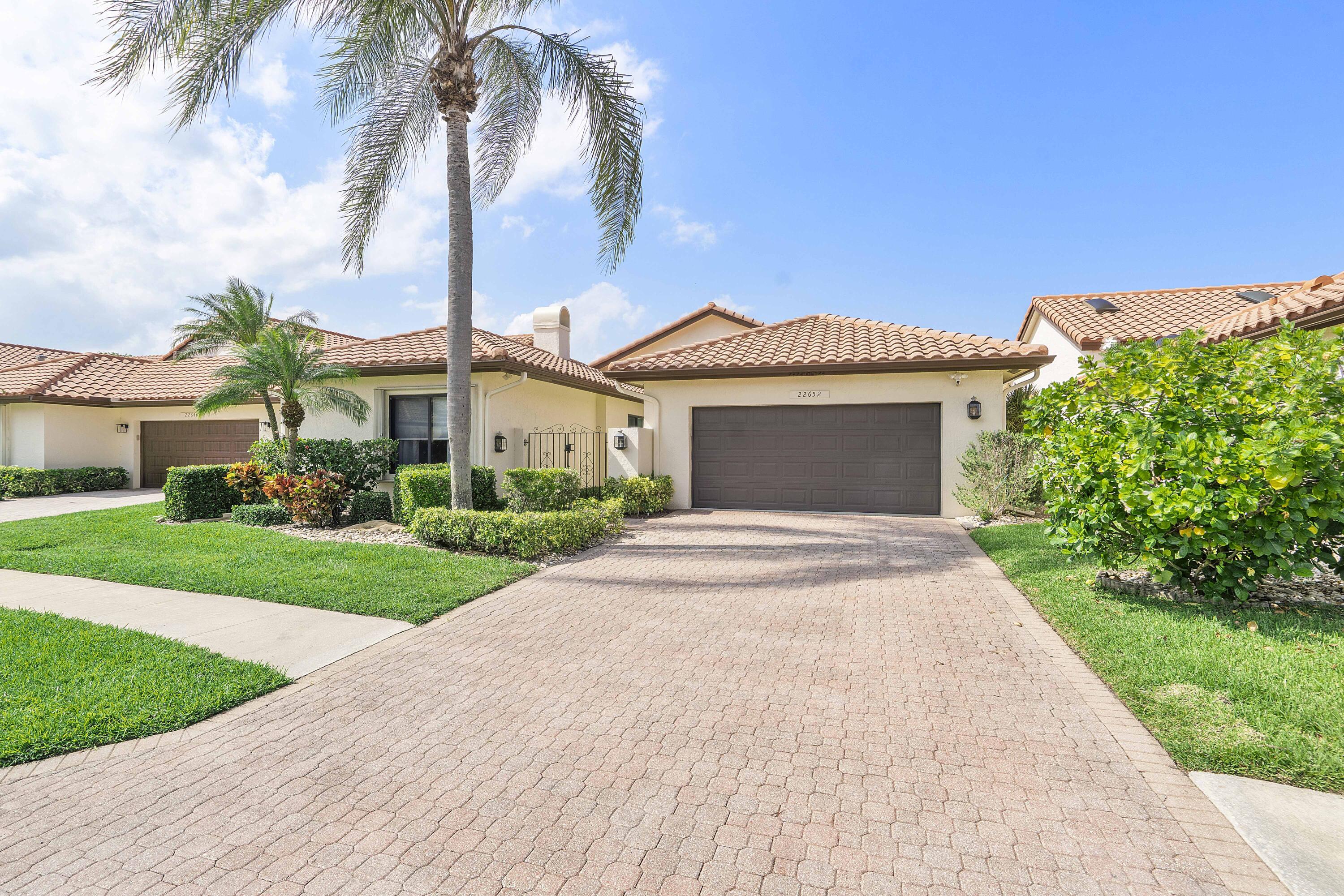 22652 Esplanada Circle Boca Raton, FL 33433 - Photo 22 of 44 a front view of a house with a garden and yard