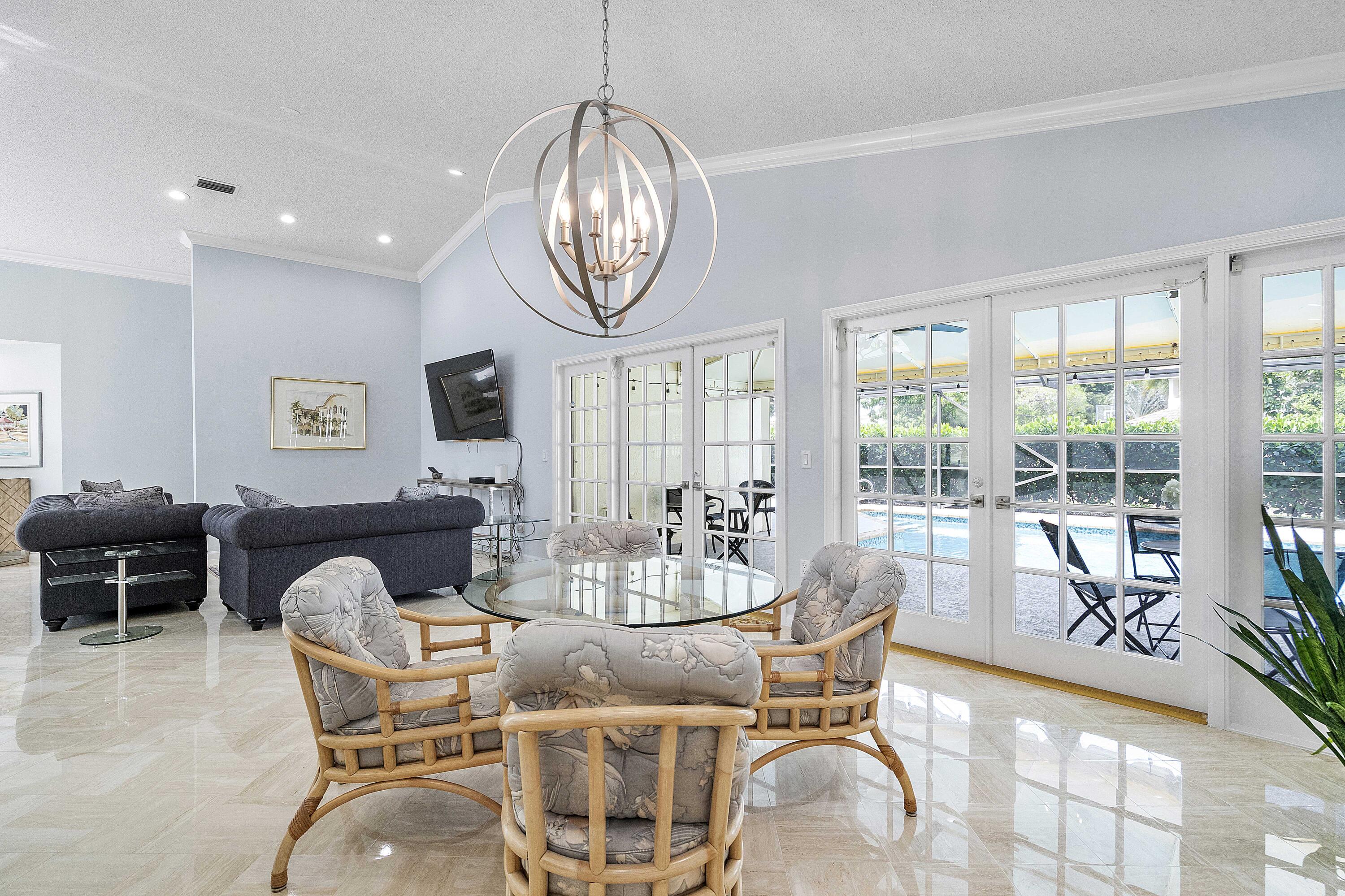 22652 Esplanada Circle Boca Raton, FL 33433 - Photo 7 of 44 a dining room with furniture a chandelier and wooden floor