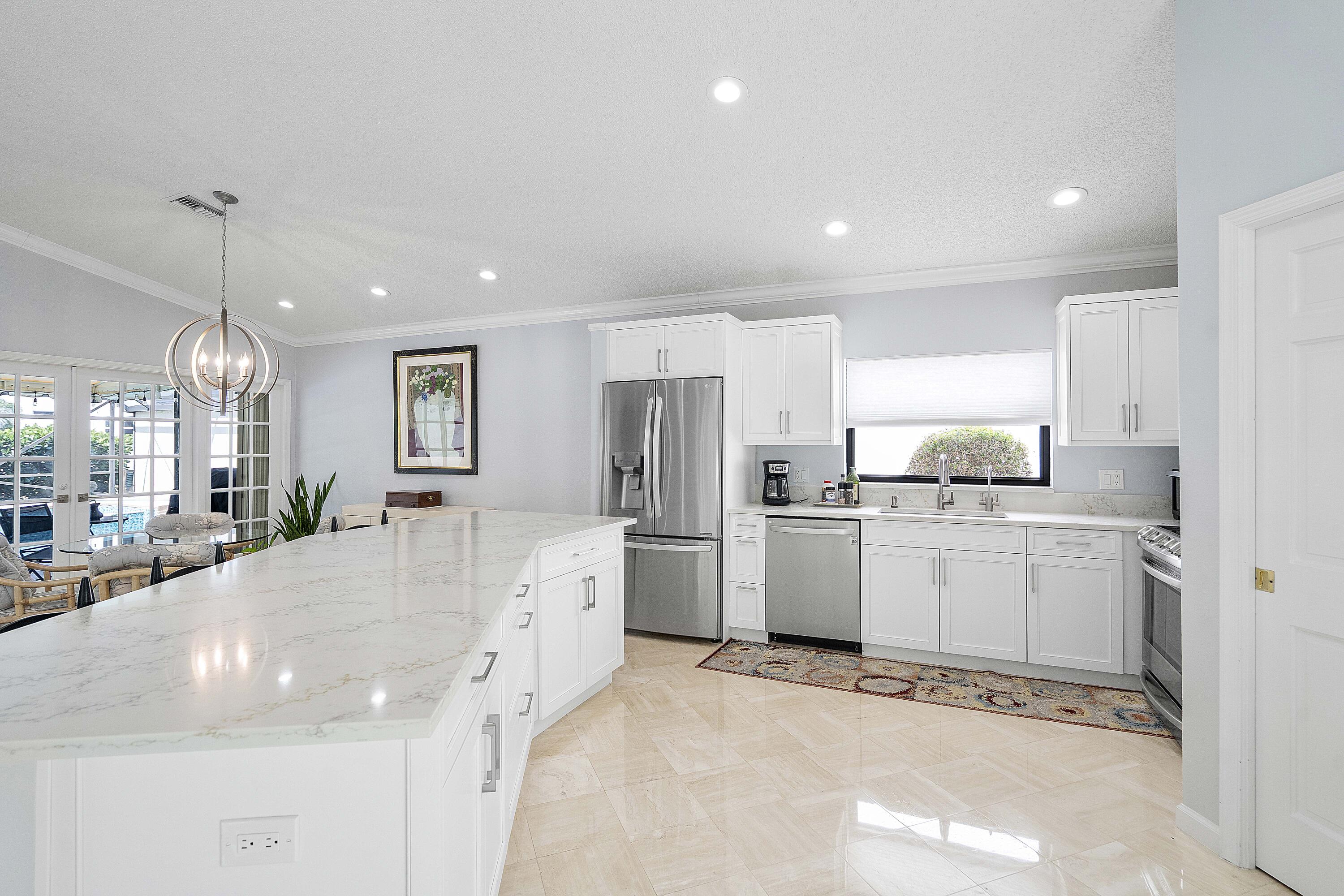 22652 Esplanada Circle Boca Raton, FL 33433 - Photo 8 of 44 a large white kitchen with refrigerator stove and a sink